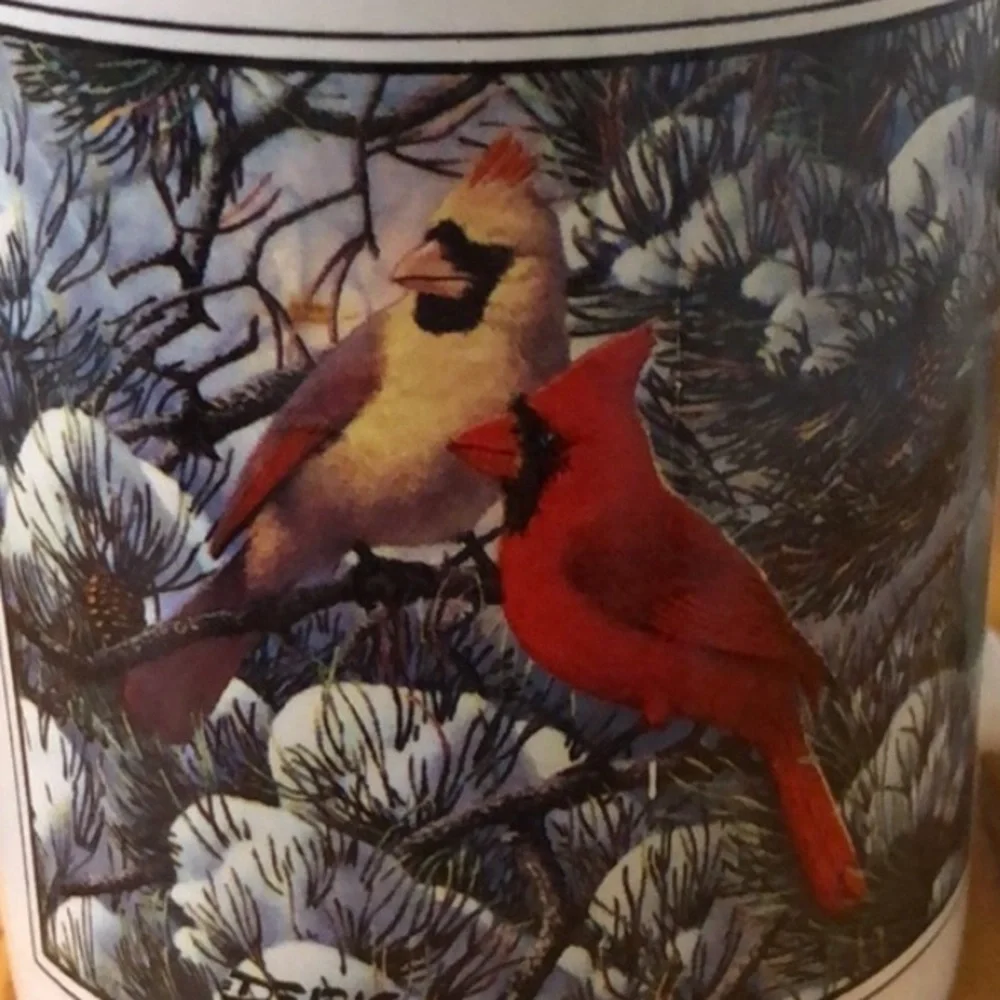 Coffe cup with cardinals in winter scene
